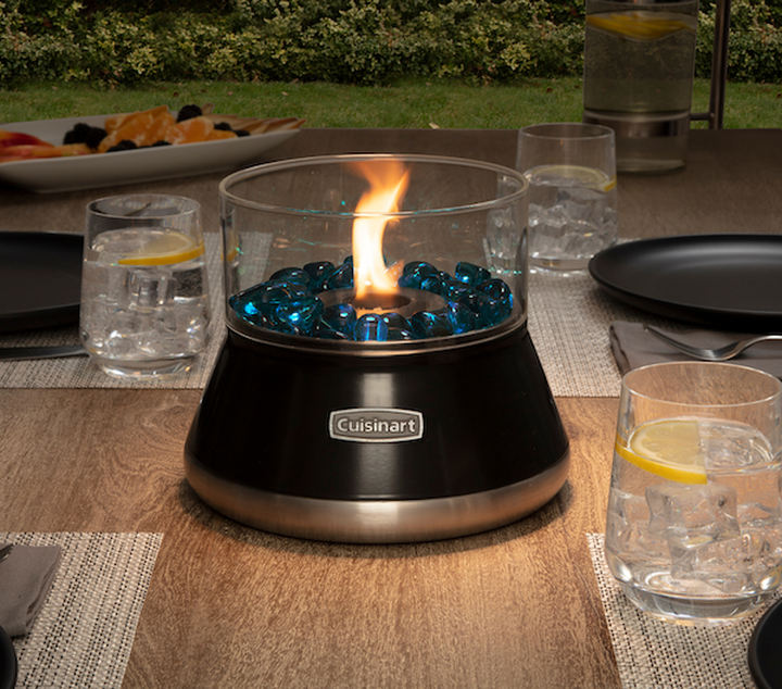black fire bowl on table with flame