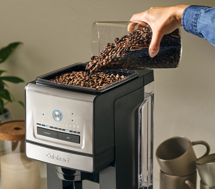 coffe beans being poured into coffee maker