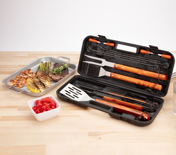 wooden handle grill tool set on counter top with cooked food