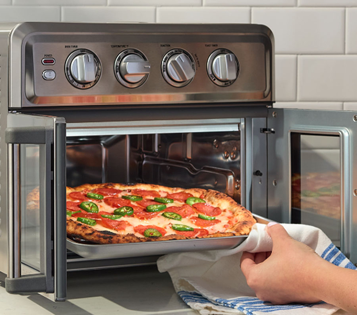 French Door Air Fryer Toaster Oven with a pizza being removed