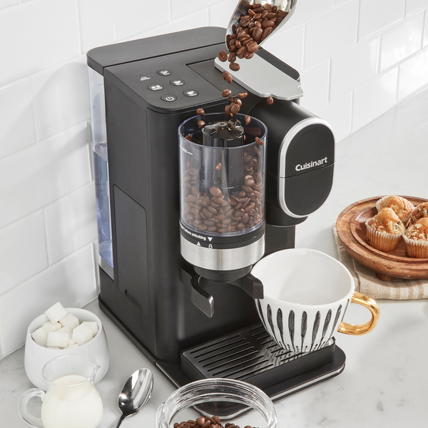 Pouring coffee beans into the Cuisinart grind-and-brew single-serve coffee maker