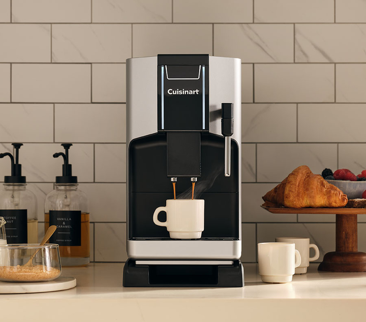 Cuisinart espresso machine on countertop pouring espresso into a mug.