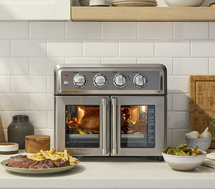 Cuisinart Artisan French Door Air Fryer Toaster oven with plate of cooked steak and french fries