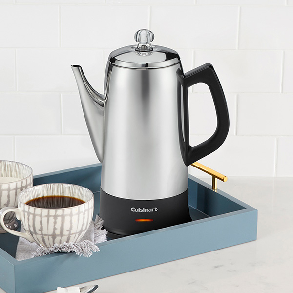 Cuisinart percolator coffee maker with a cup of coffee on a blue tray