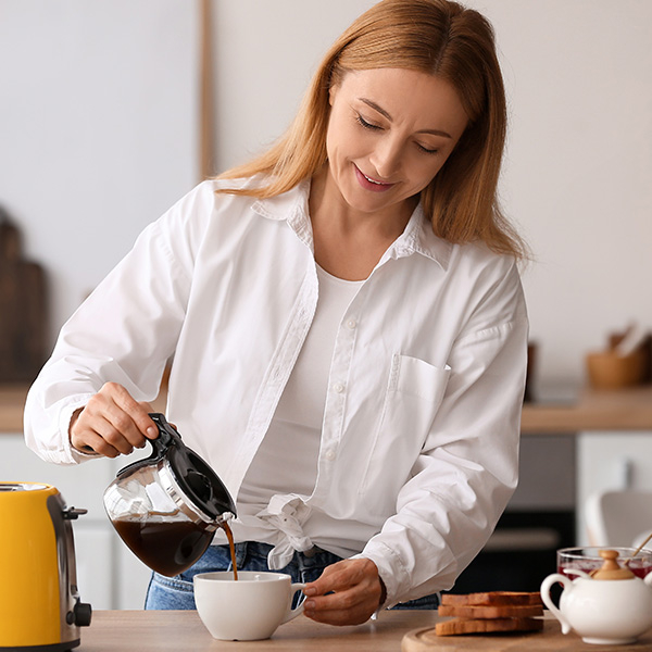 Pouring a cup of coffee from a coffee pot