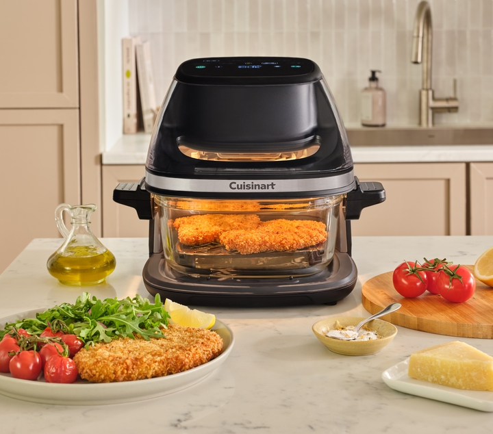 TOASTER OVEN WITH FOOD COOKING SIDE, DELICIOUS FOOD AROUND IT