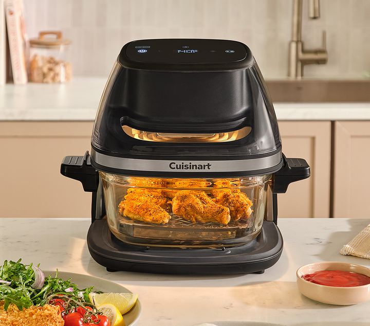 Cuisinart air fryer on countertop cooking fried chicken