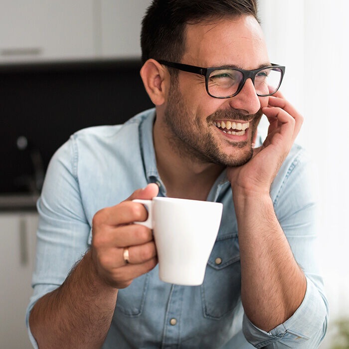 man holding coffee cup
